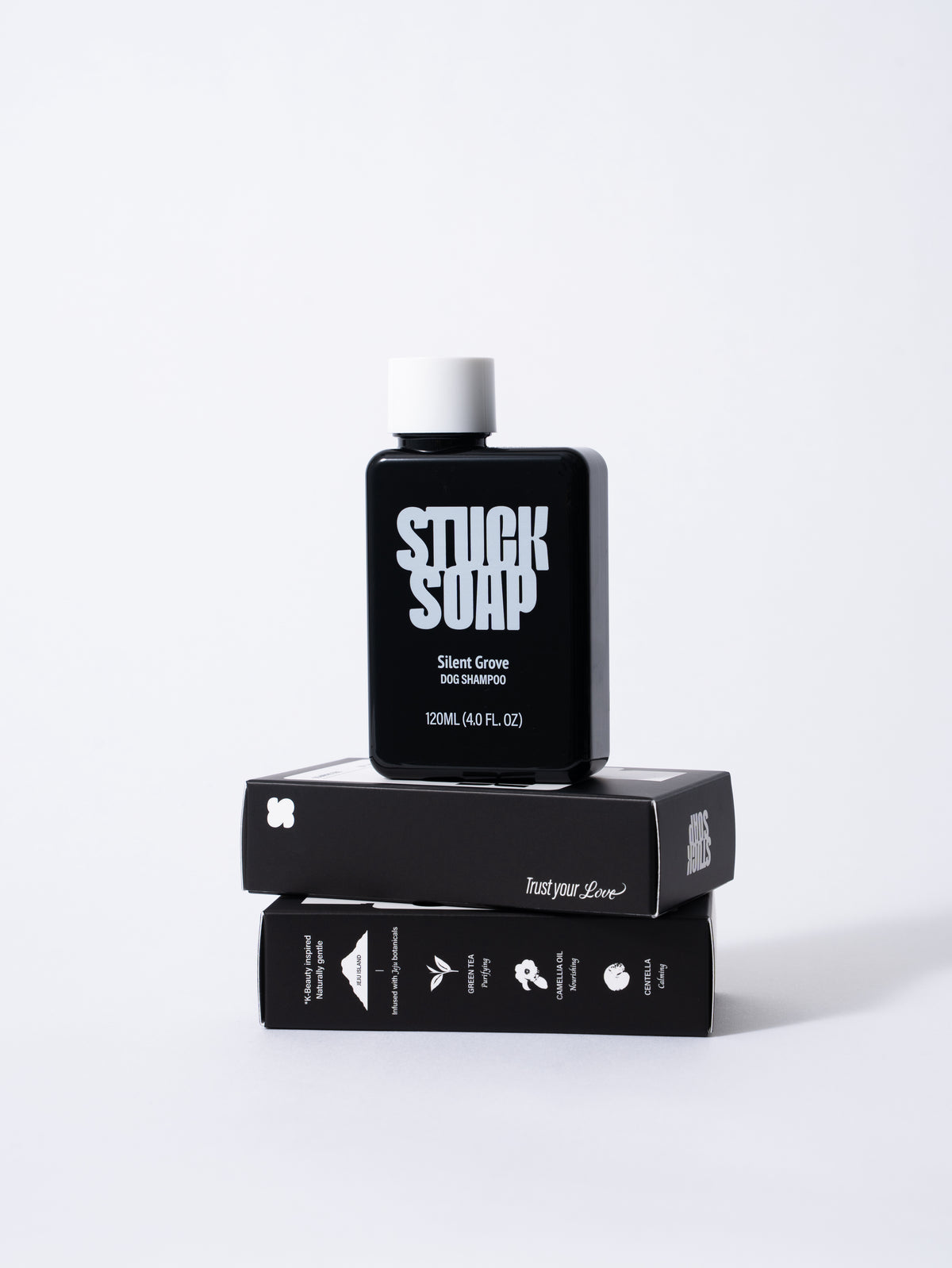 Black Silent Grove 120 ml bottle standing on two stacked shampoo cartons
