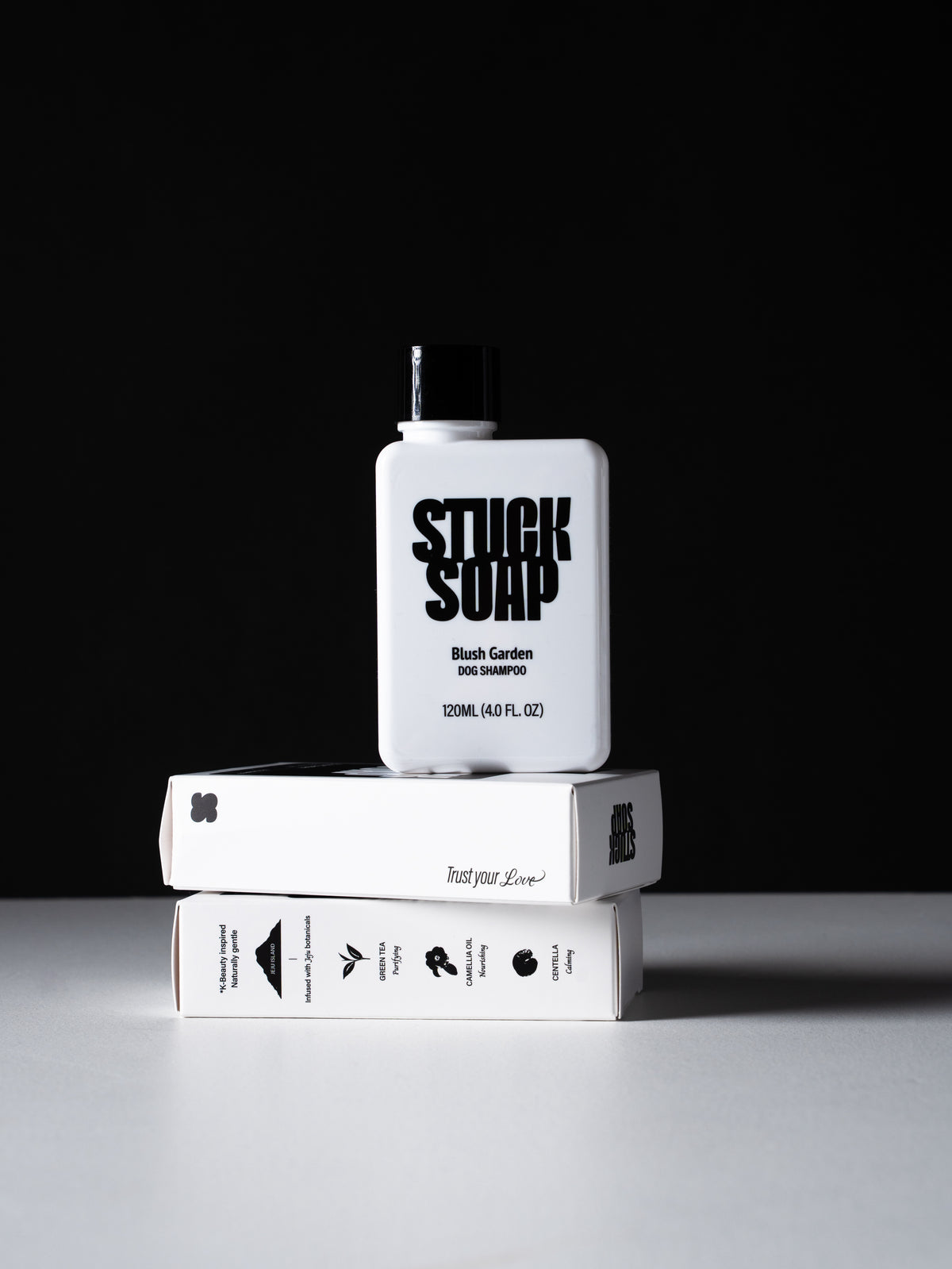 White Blush Garden 120 ml bottle standing on two stacked white cartons against a black background