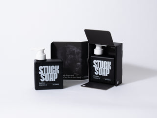 Two black Silent Grove 500 ml pump bottles, one beside an open box printed with a black dog photograph