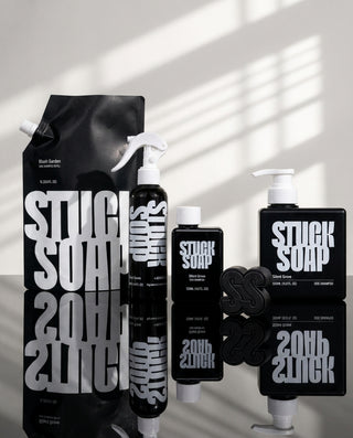 Silent Grove 1 L refill pouch, spray bottle, 120 ml bottle, 500 ml pump bottle and black soap bar in sunlight