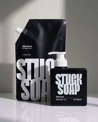 Black Silent Grove 1 L refill pouch standing behind a black Silent Grove 500 ml pump bottle